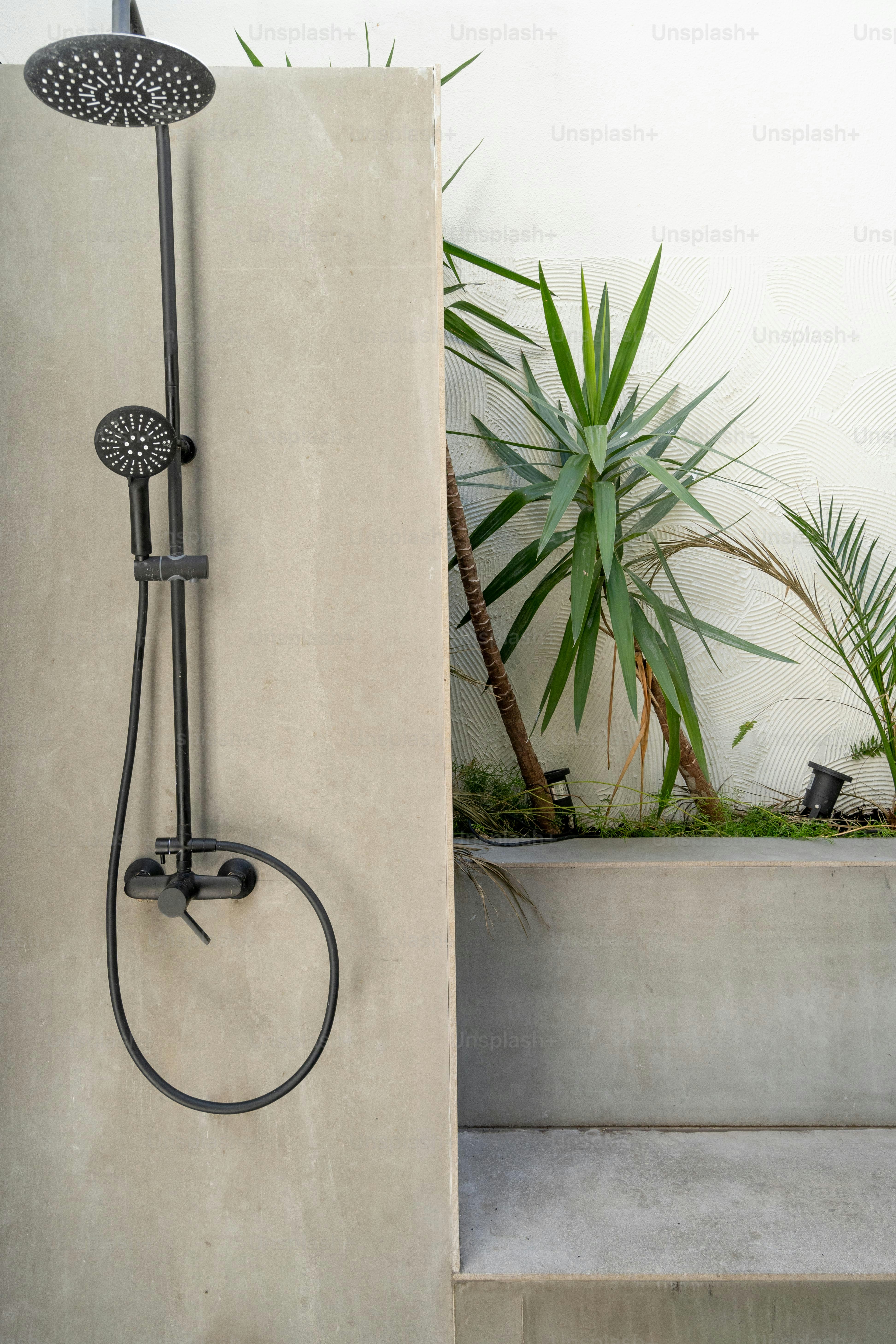 a shower head and hand shower in a bathroom