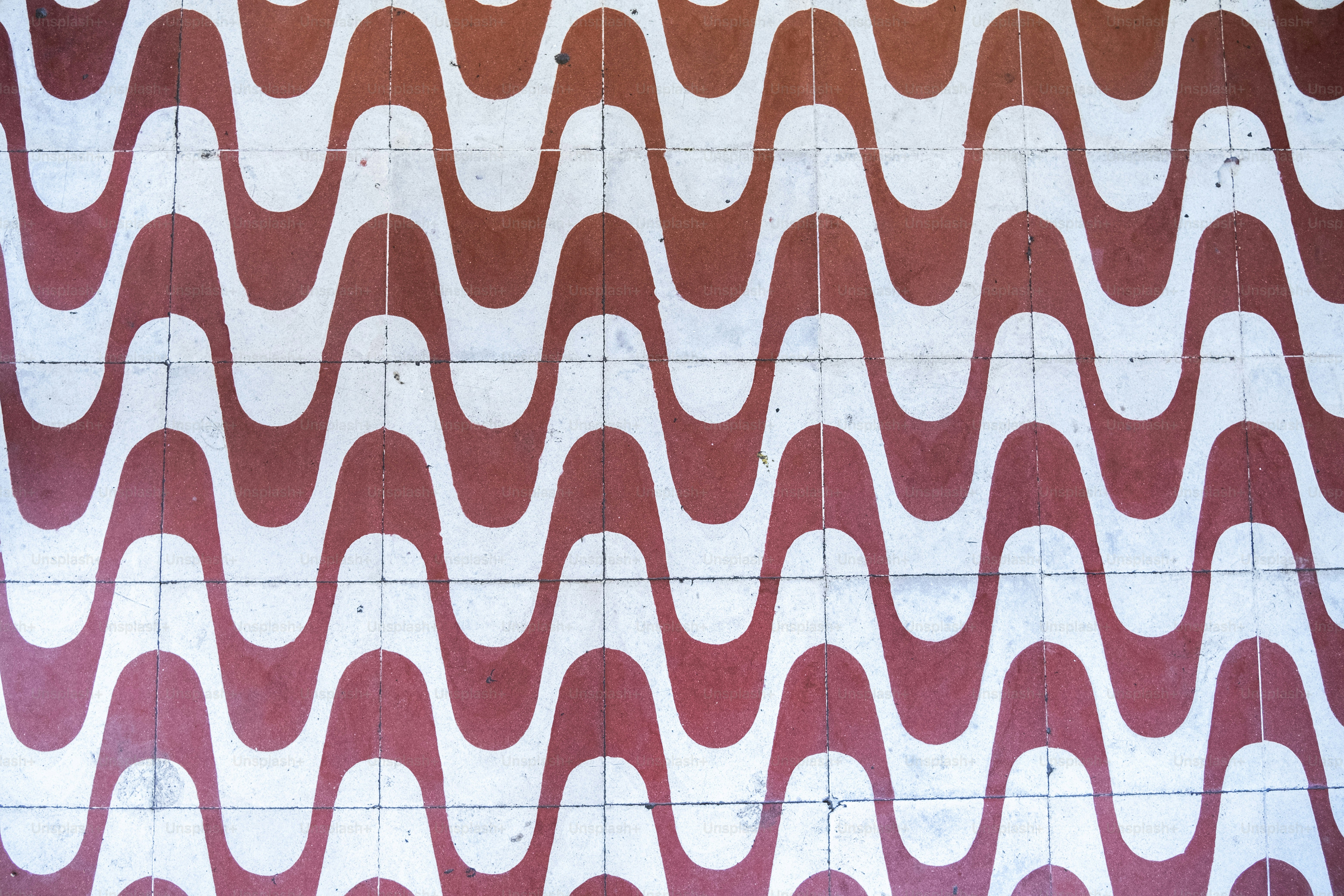 a red and white wall with a pattern on it