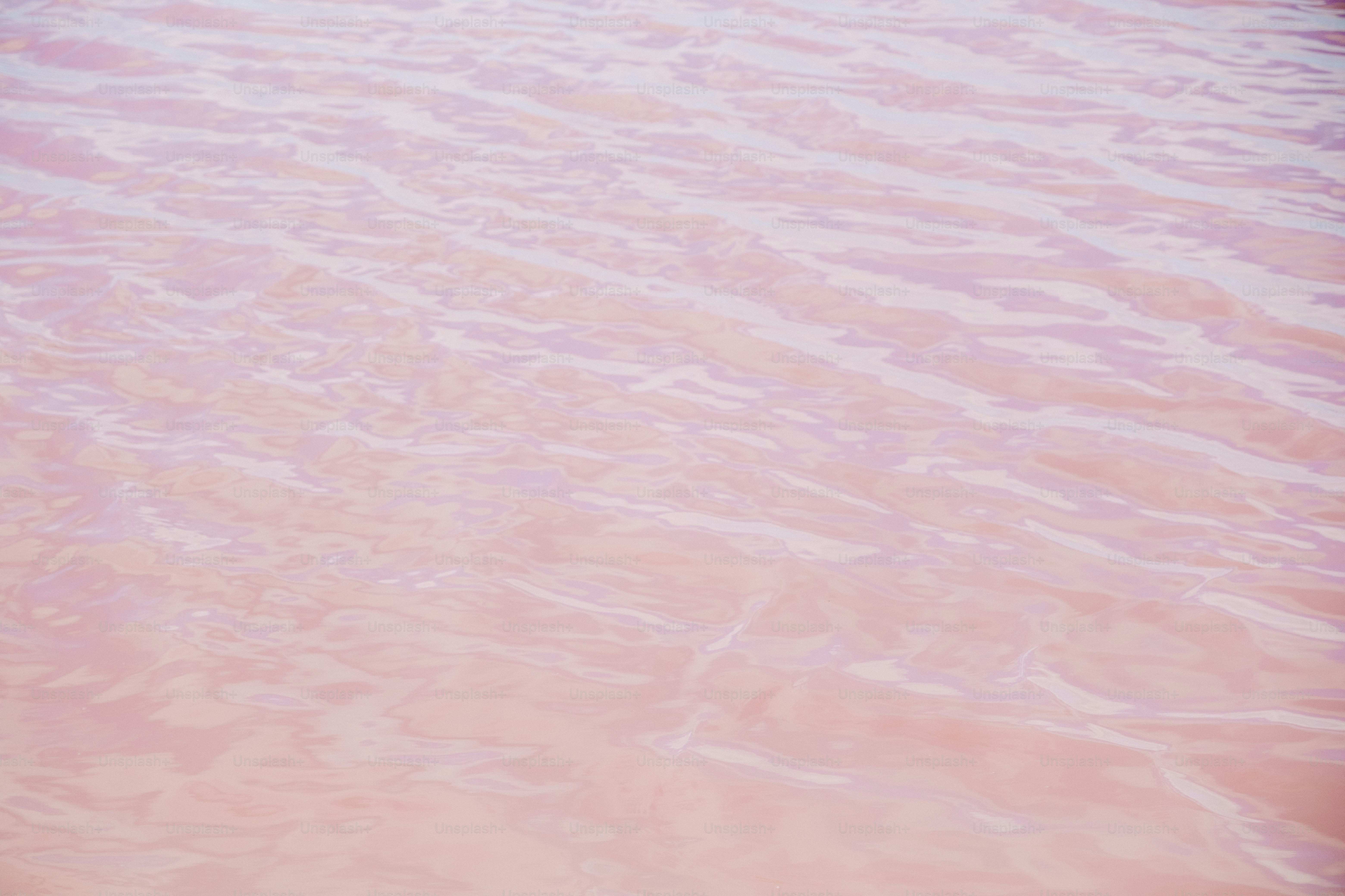 a red boat floating on top of a body of water