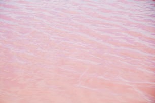 a red boat floating on top of a body of water