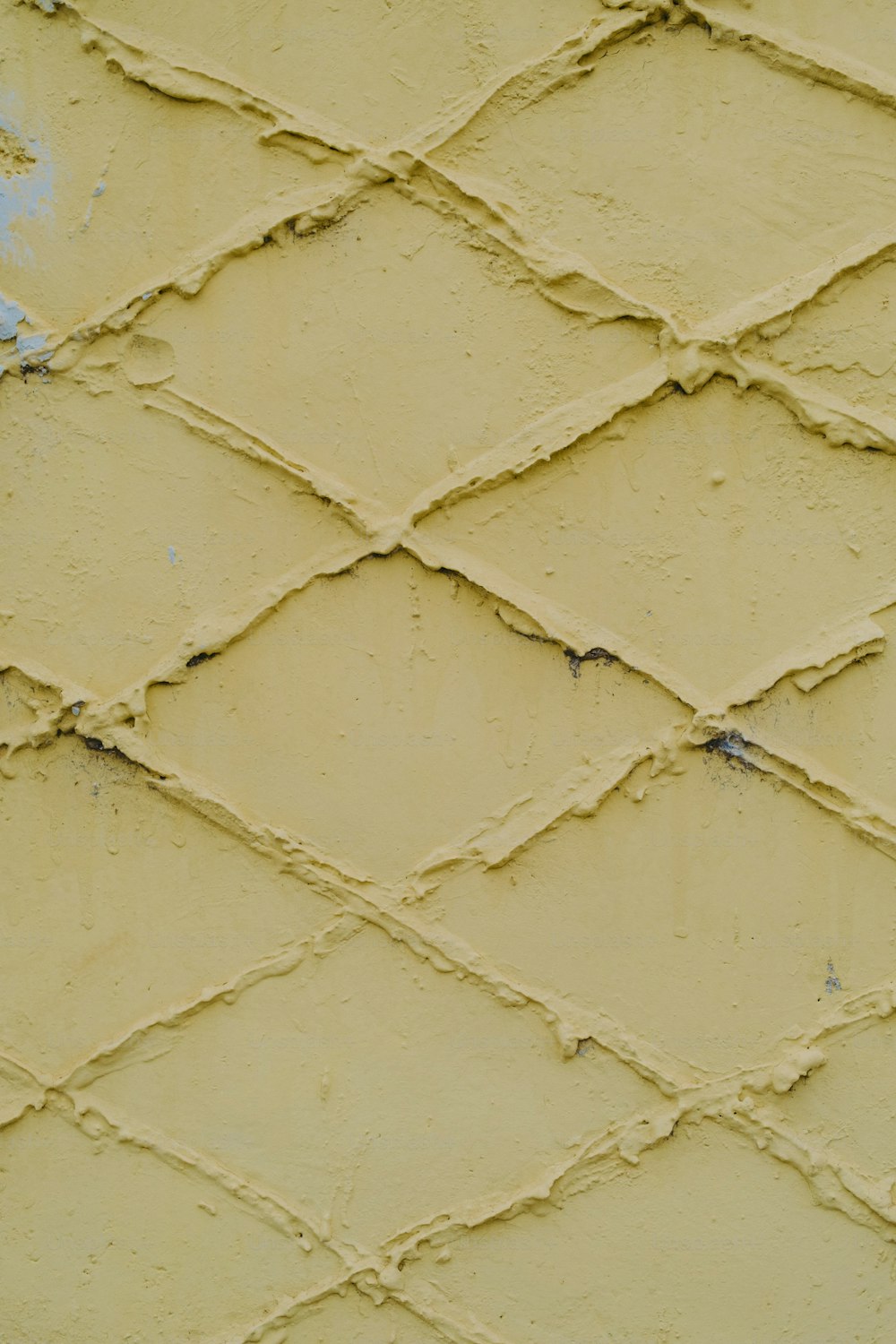 a close up of a yellow painted wall