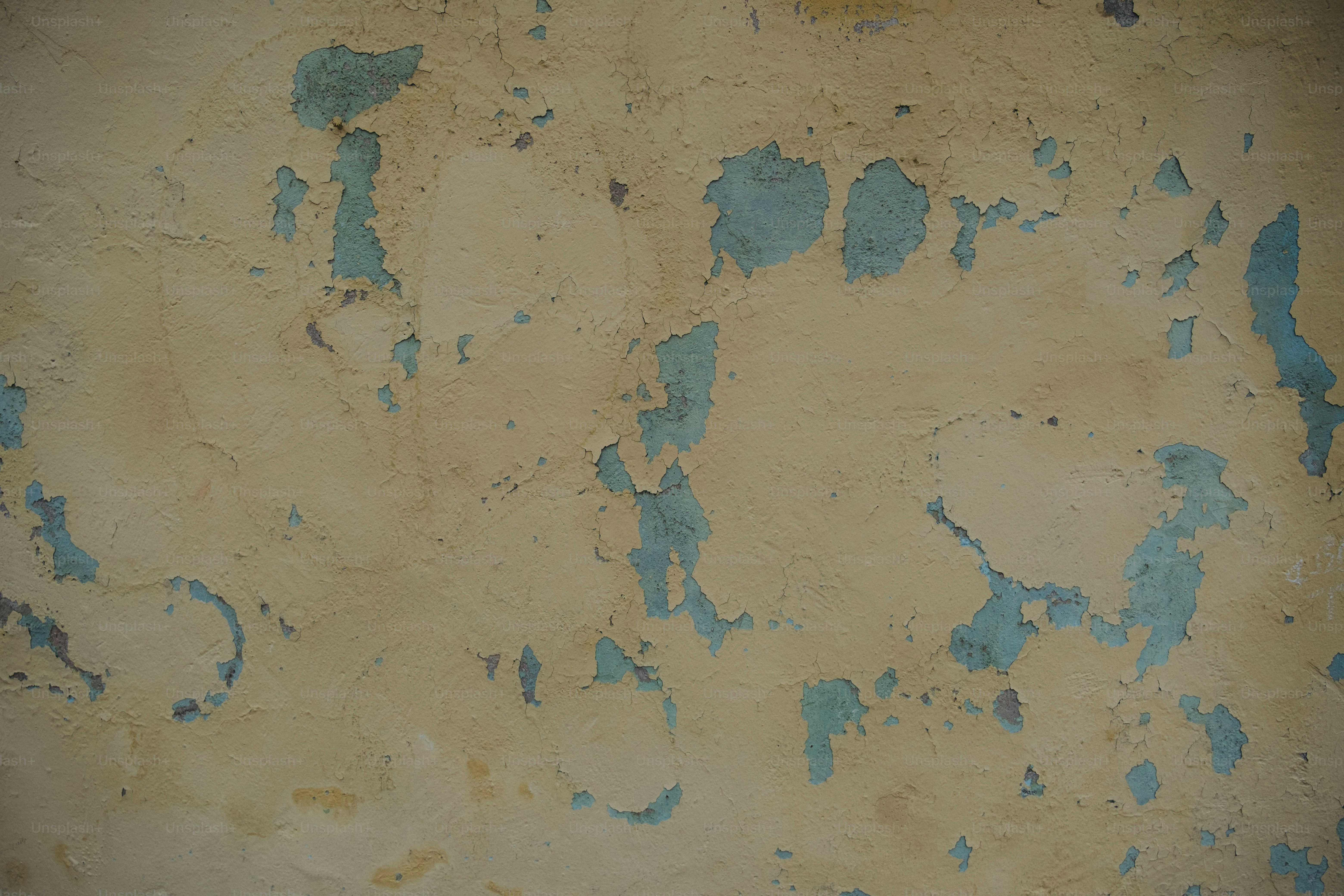 a wall with peeling paint on it