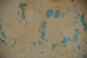 a wall with peeling paint on it