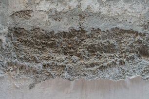 a close up of a rock wall with a red object in the middle of it