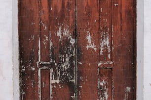 an old wooden door with peeling paint on it