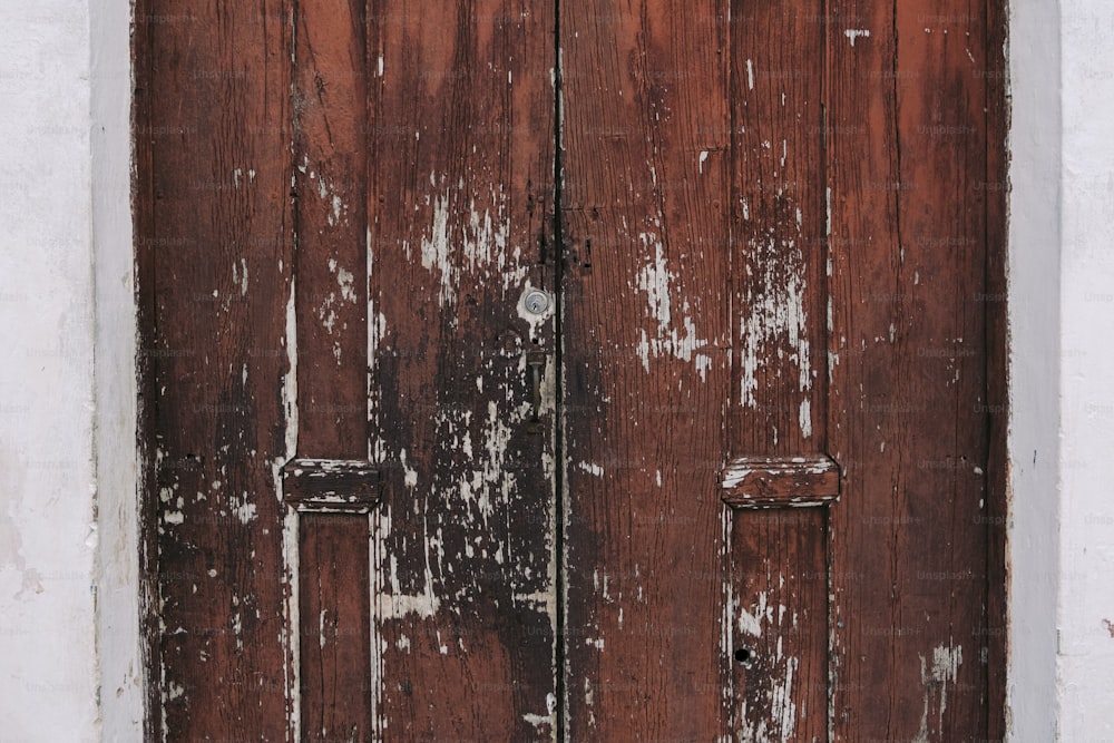 an old wooden door with peeling paint on it