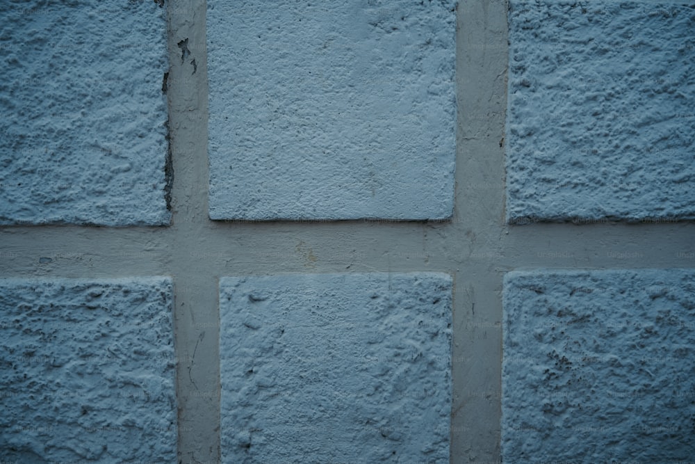 a close up of a blue brick wall