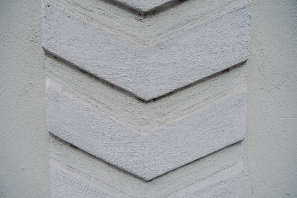 a close up of a white wall with a chevron pattern