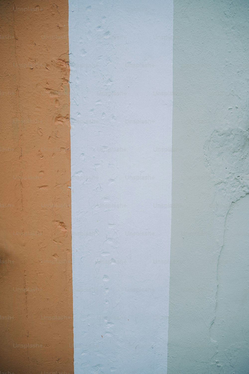 an orange and white wall with a clock on it