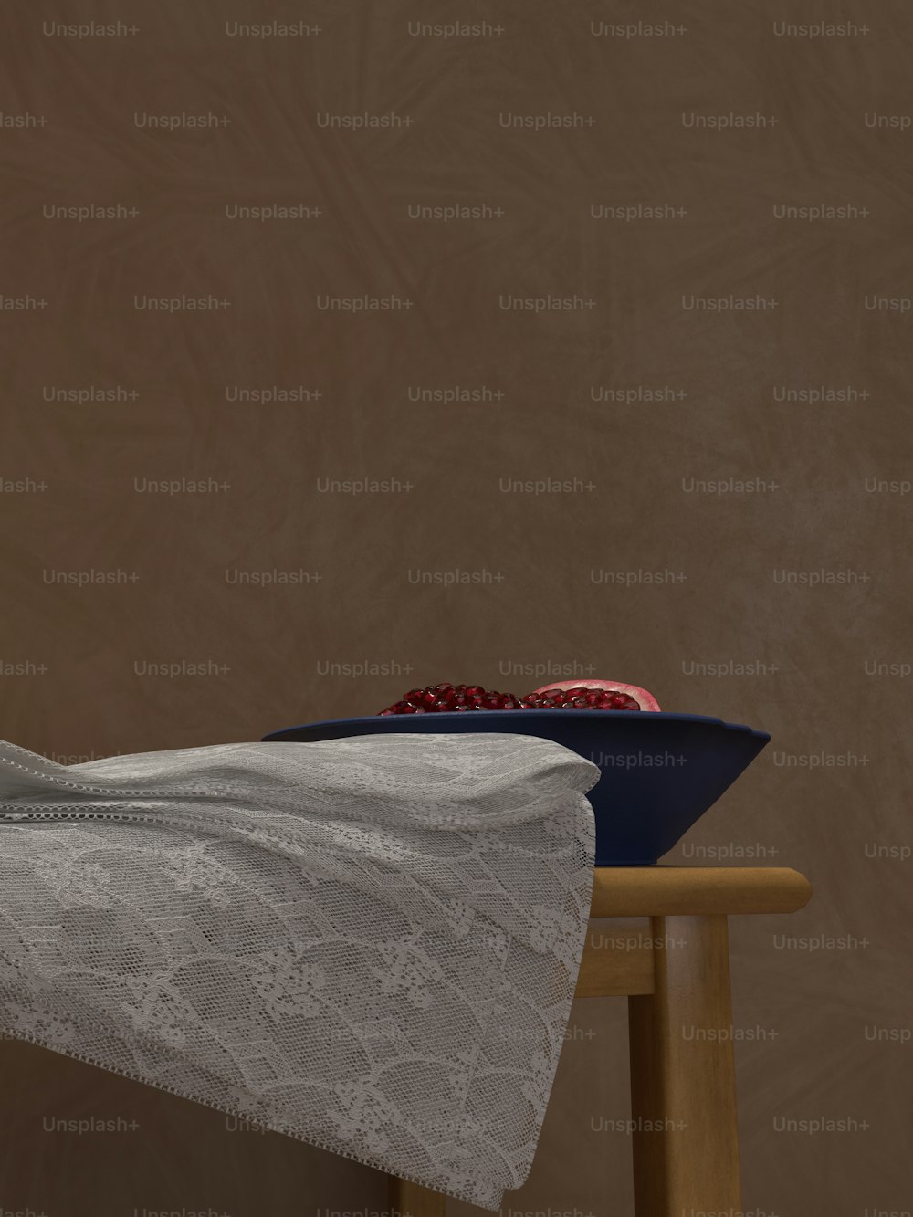 a table topped with a white table cloth and a bowl of fruit