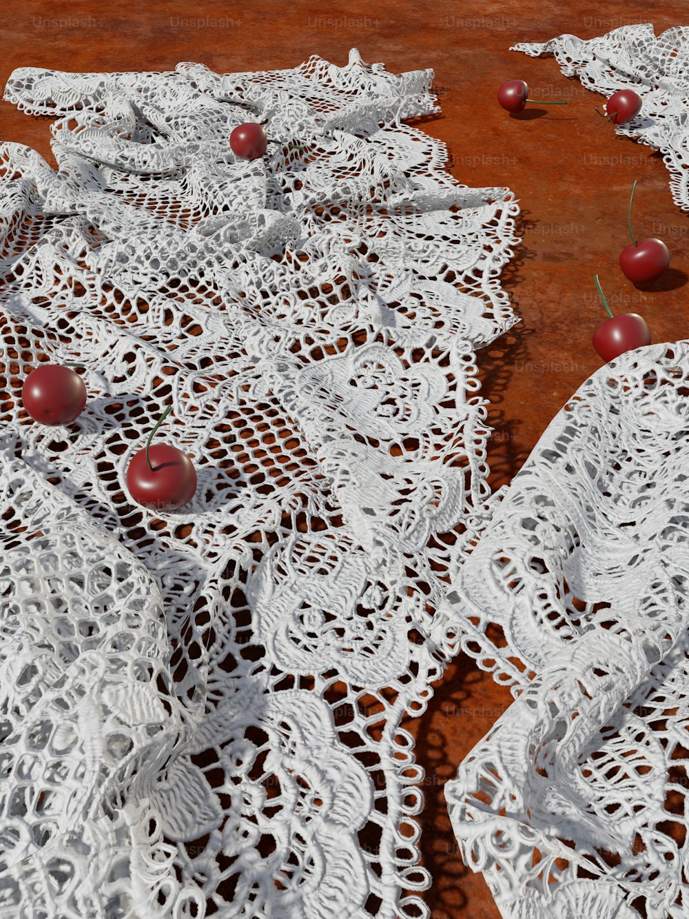 a table topped with white lace and red apples