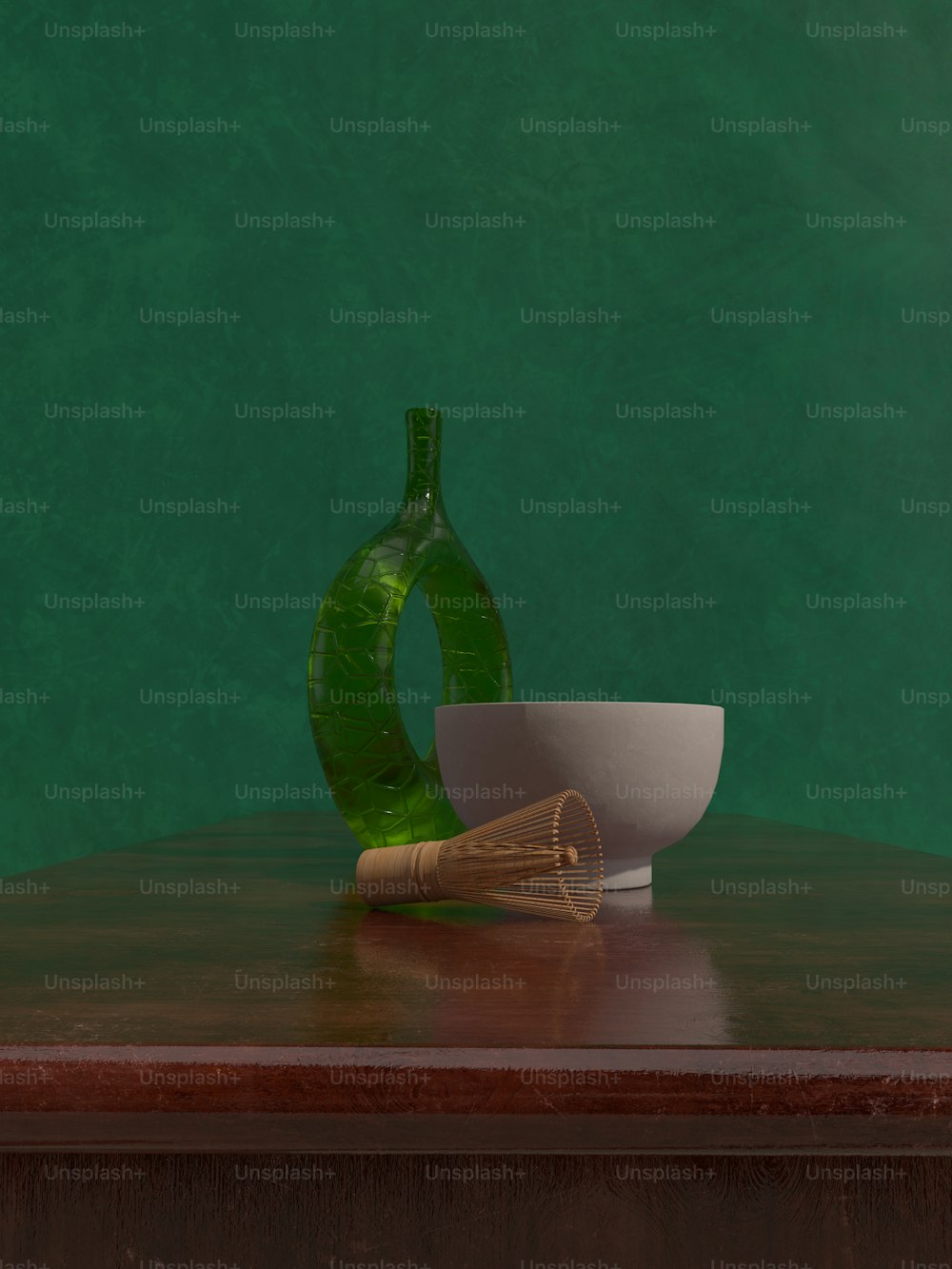 a green vase sitting on top of a wooden table