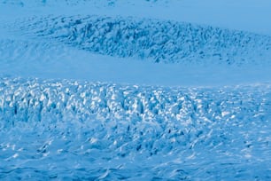 a large amount of ice on the side of a mountain