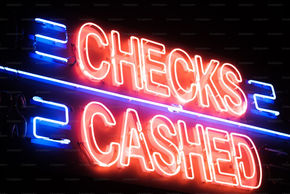 a neon sign that says checks and cashed