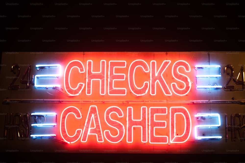 a neon sign that says checks and cashed