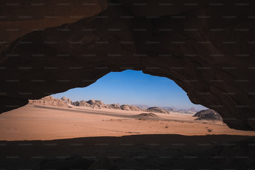 a view of the desert from inside a cave