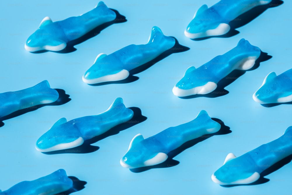 a group of blue and white fish shaped candies