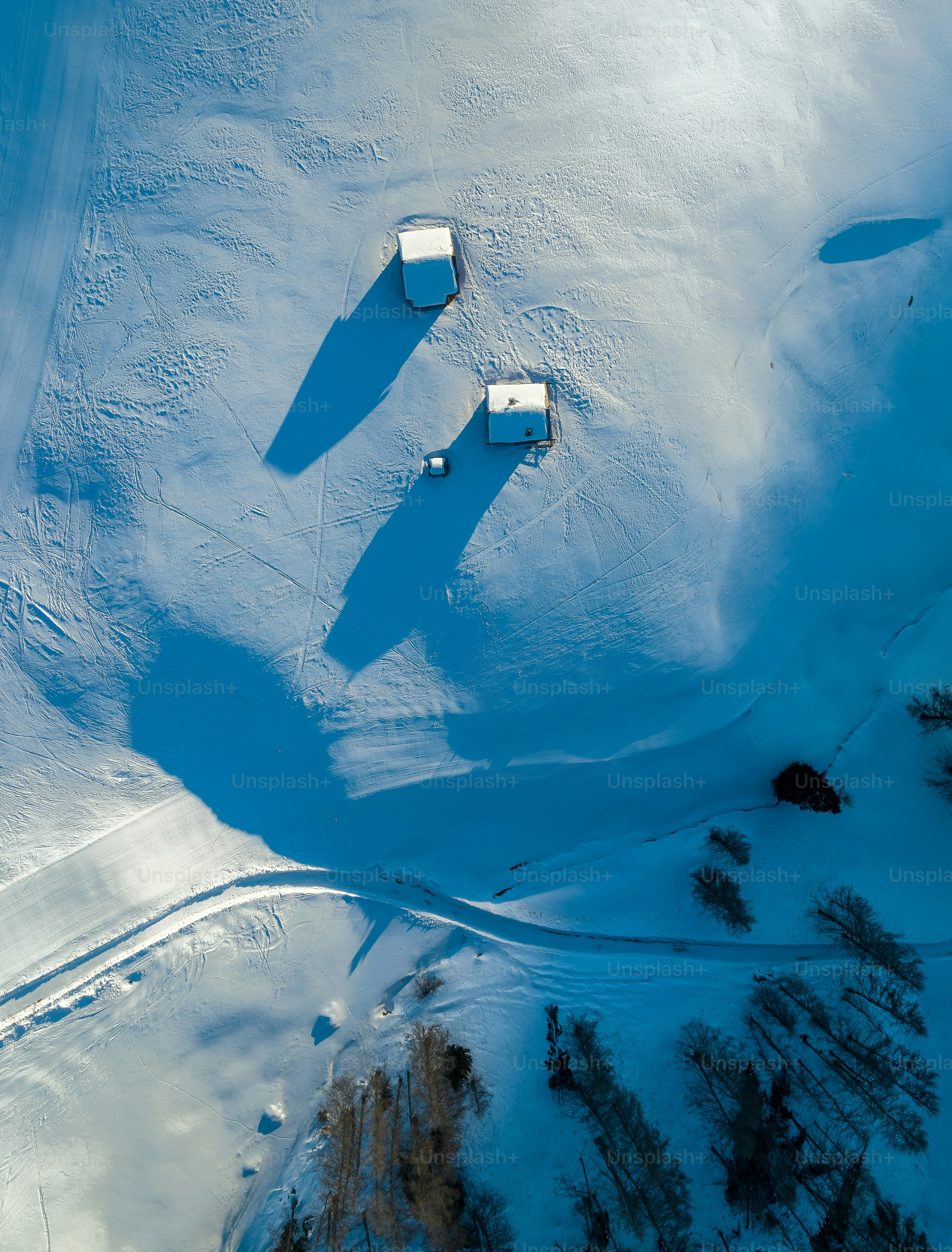 an aerial view of a snow covered field
