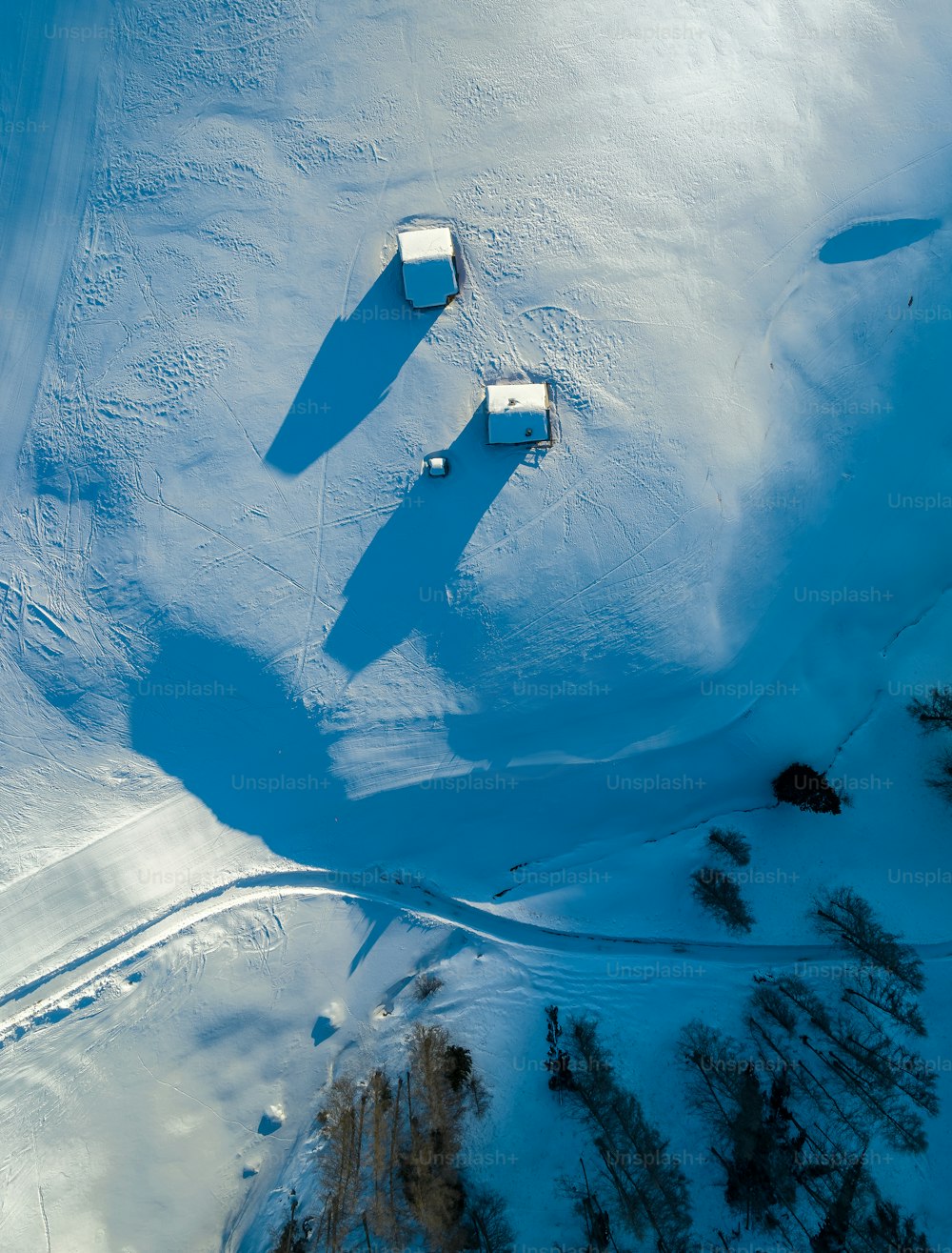 an aerial view of a snow covered field