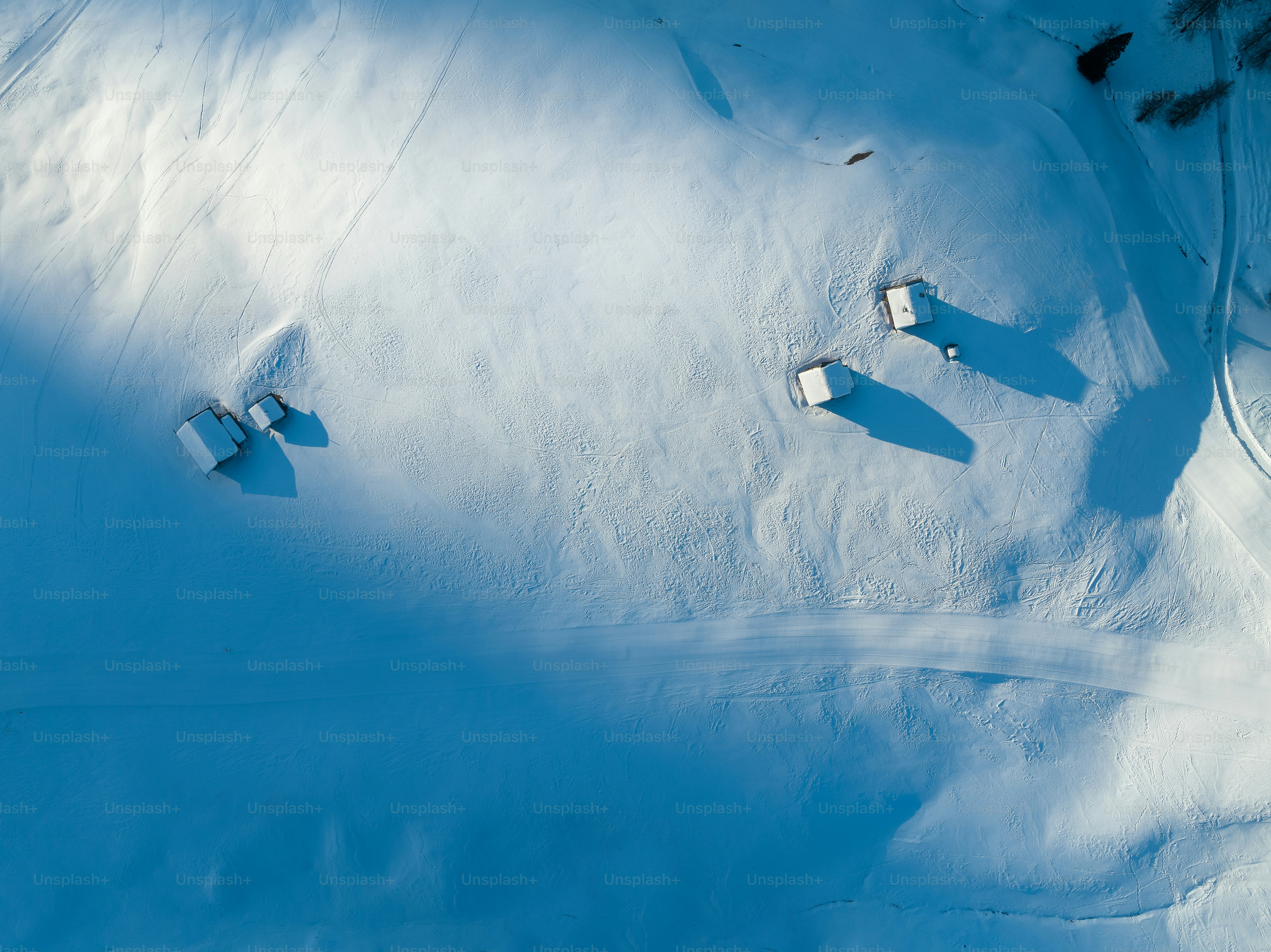 An aerial view of a snow covered field photo – Snow Image on Unsplash