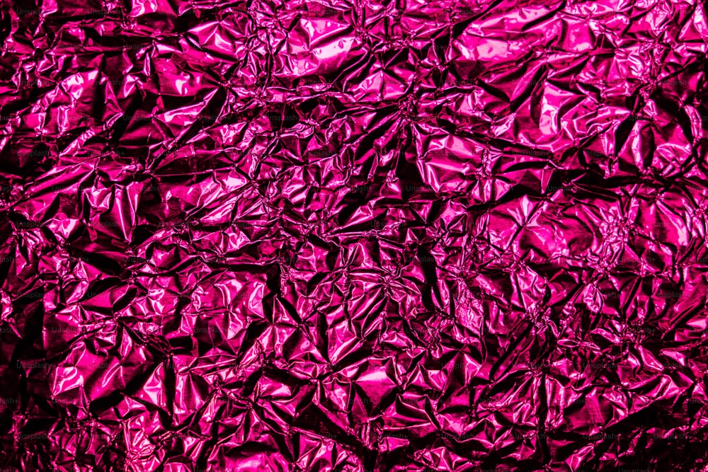 a close up view of a shiny pink surface