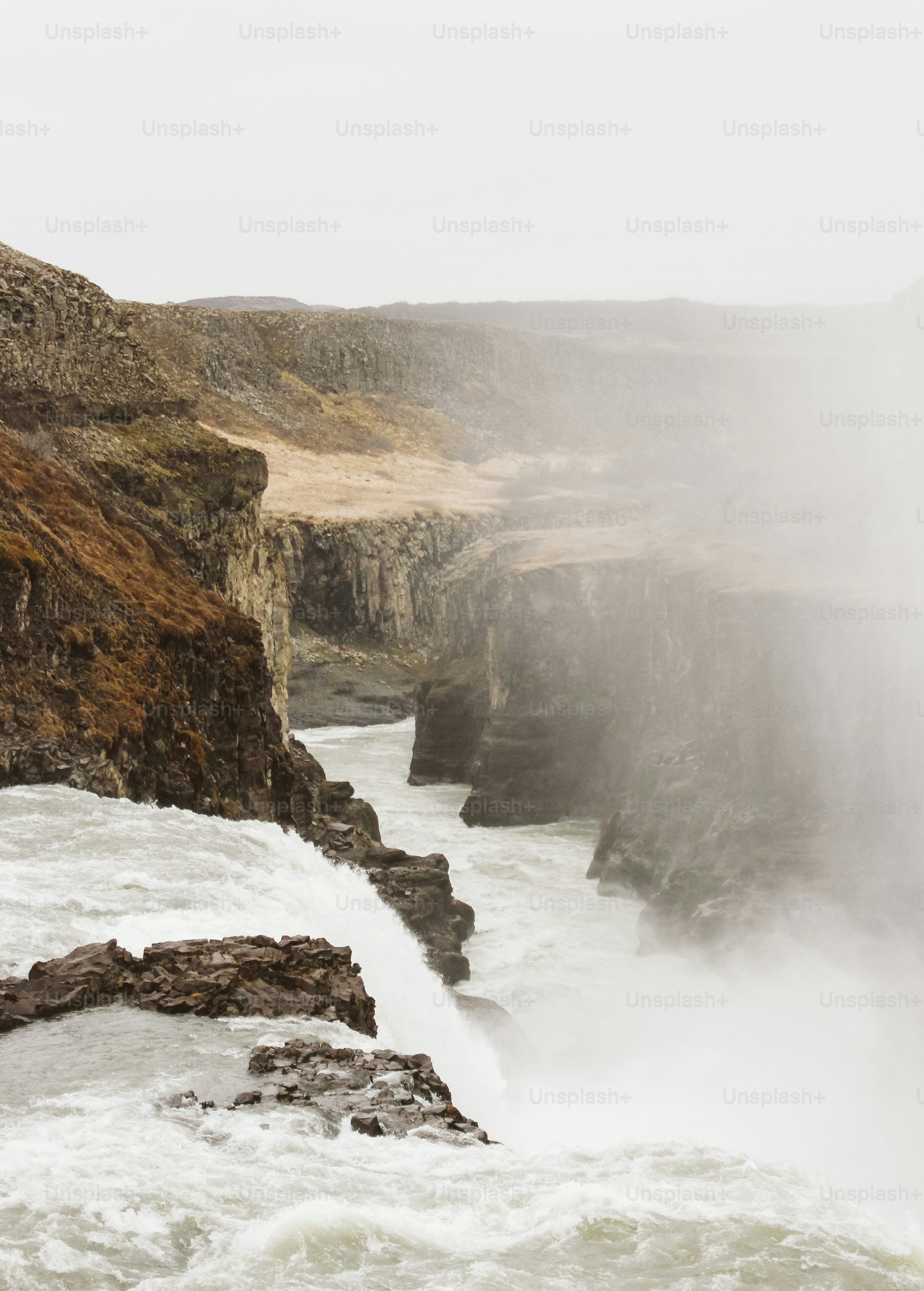 a man standing on the edge of a waterfall
