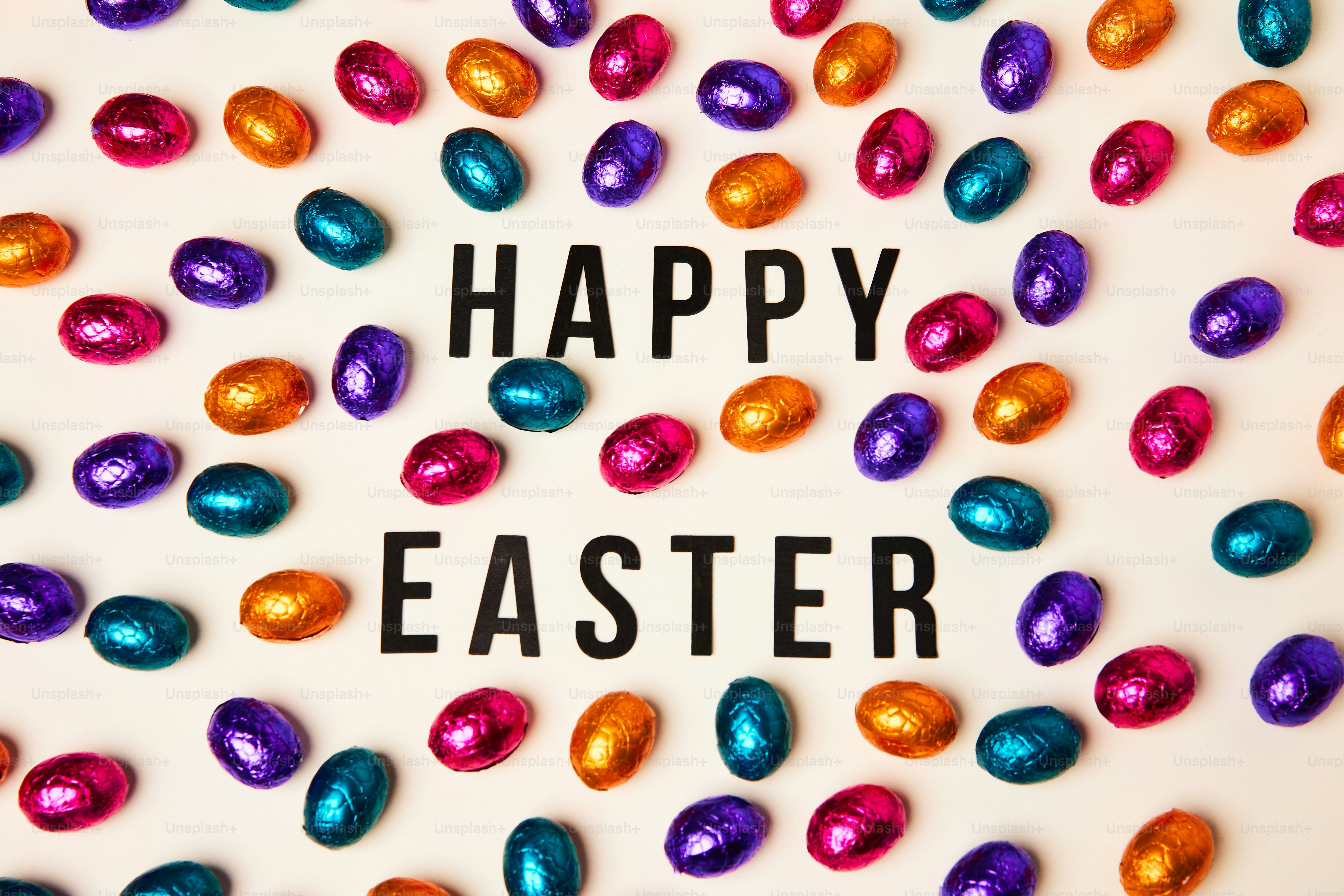 a happy easter message surrounded by chocolate eggs photo Easter eggs Image on Unsplash