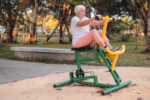 a woman is sitting on a stationary exercise bike