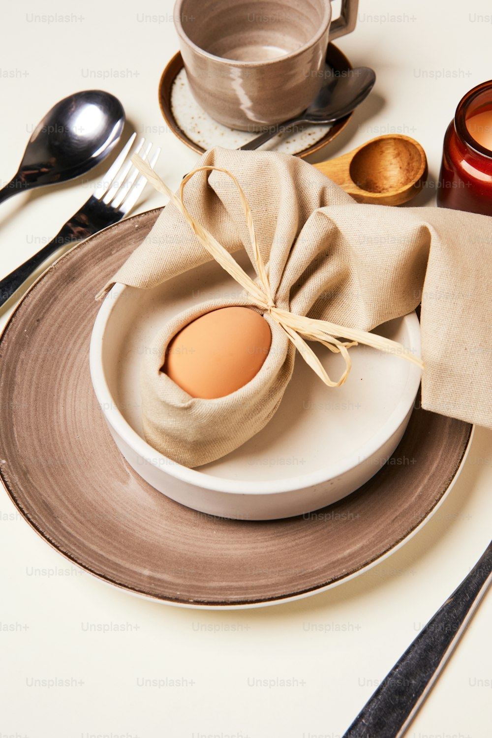 a plate with an egg on it and a napkin tied around it