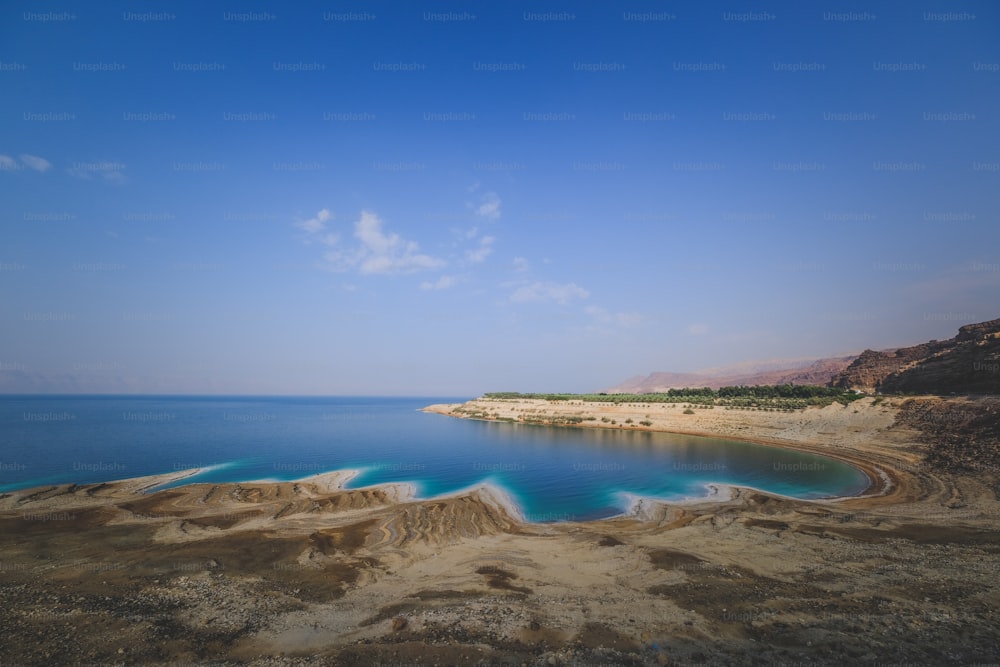 a large body of water surrounded by sand dunes