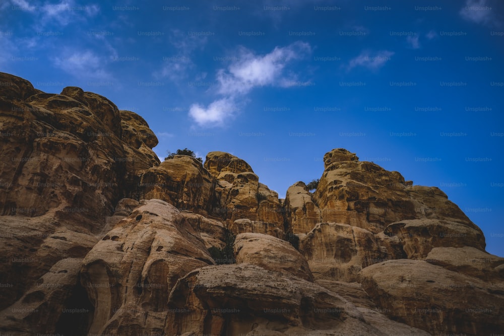 a group of rocks with a sky in the background