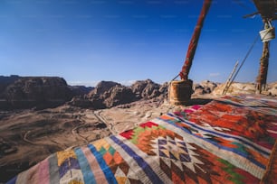 a colorful blanket on the side of a mountain