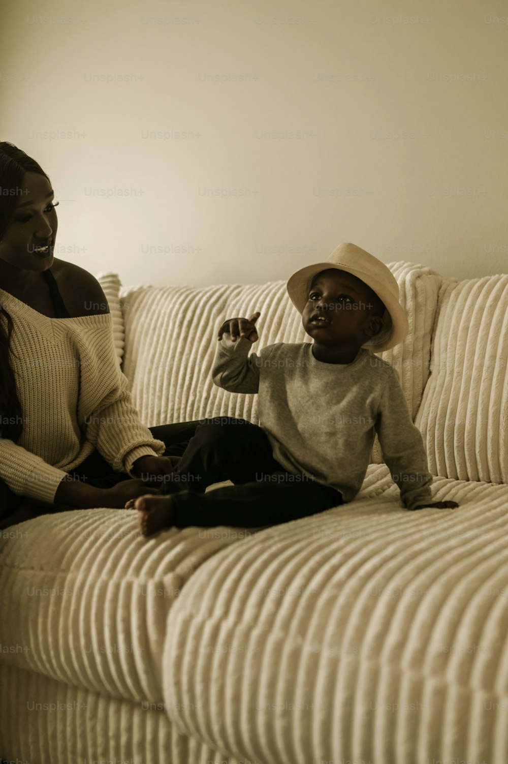a woman and a child sitting on a couch