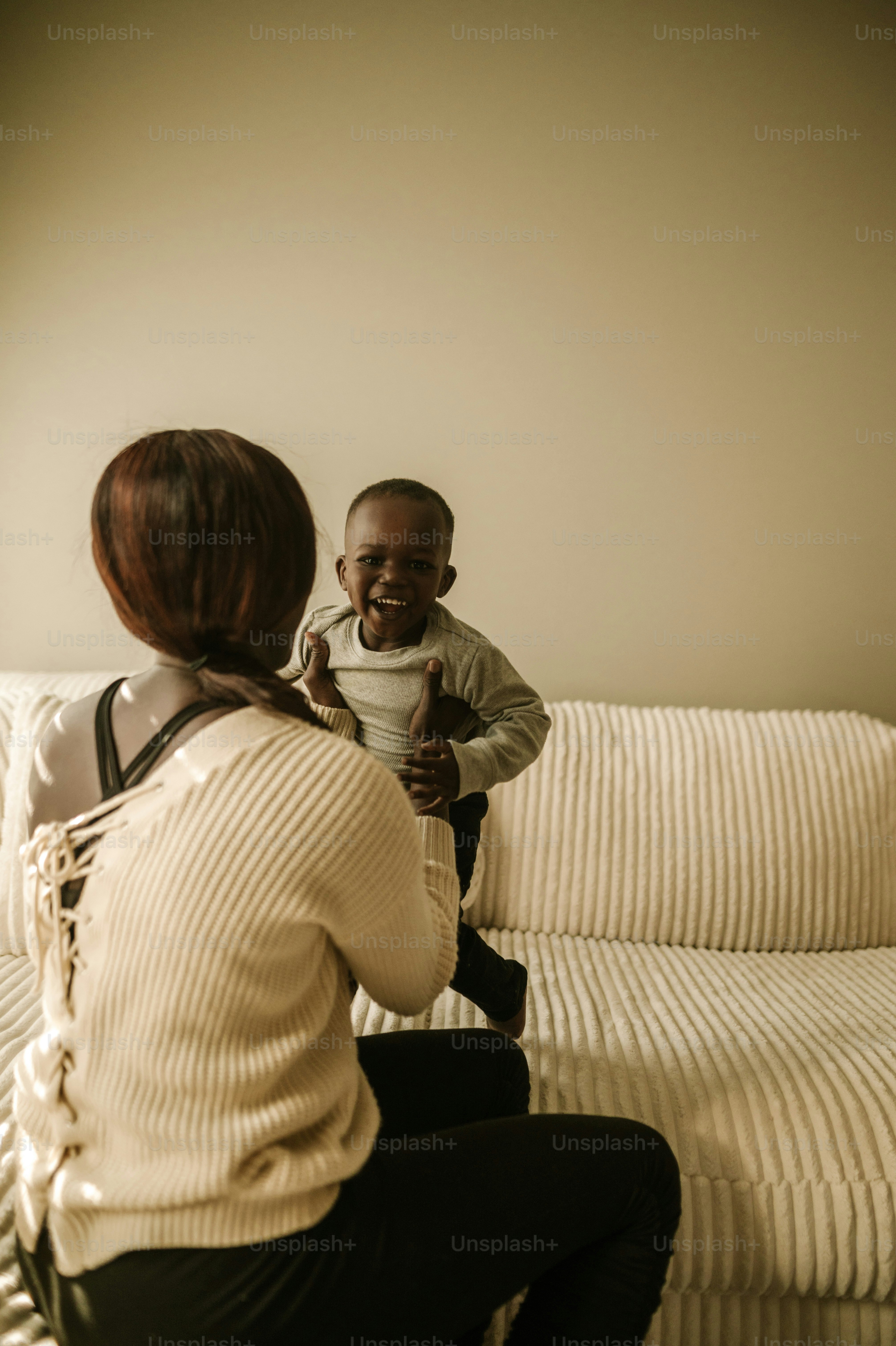 a woman and a child sitting on a couch