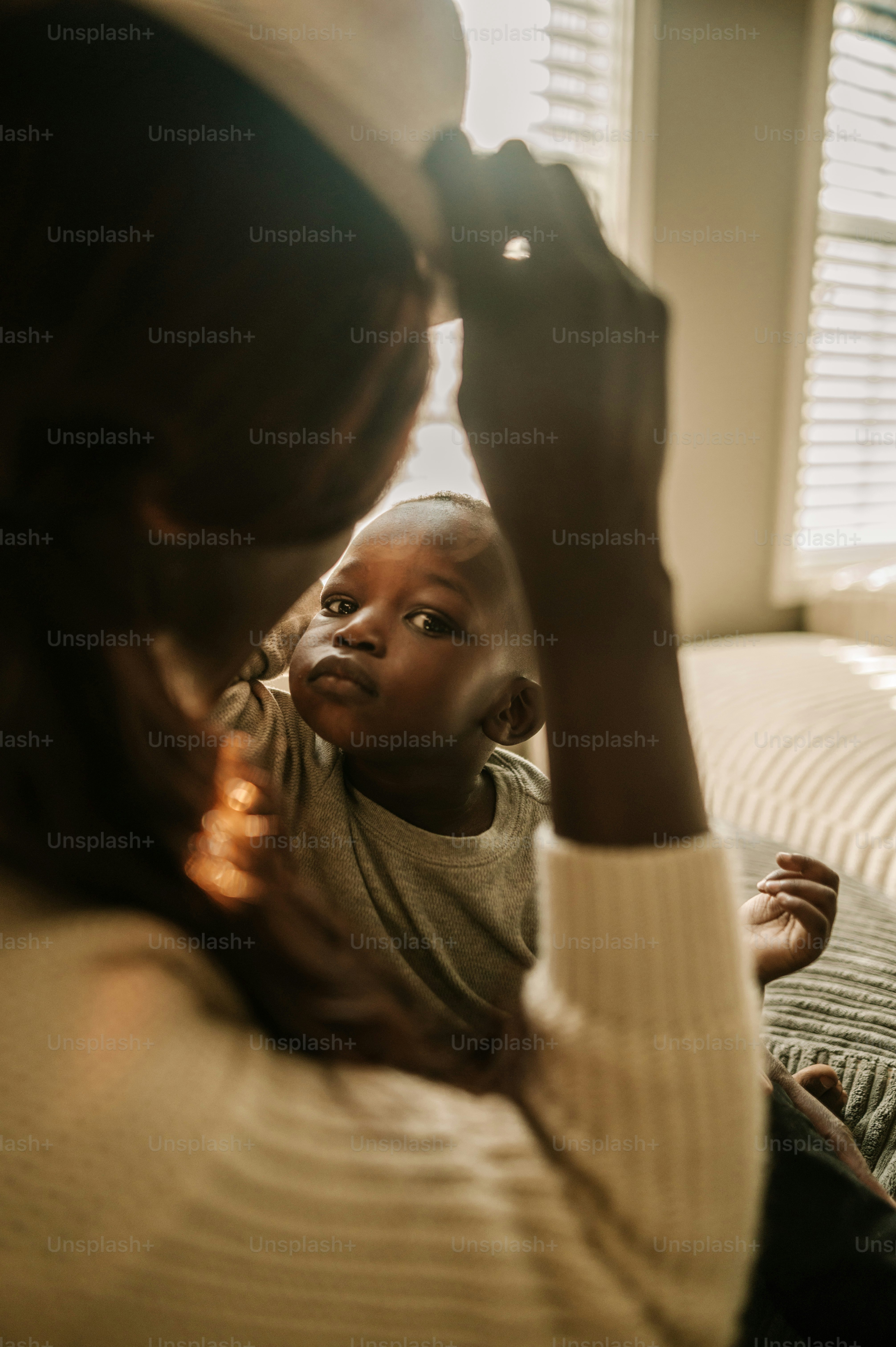 a woman holding a child up to their face