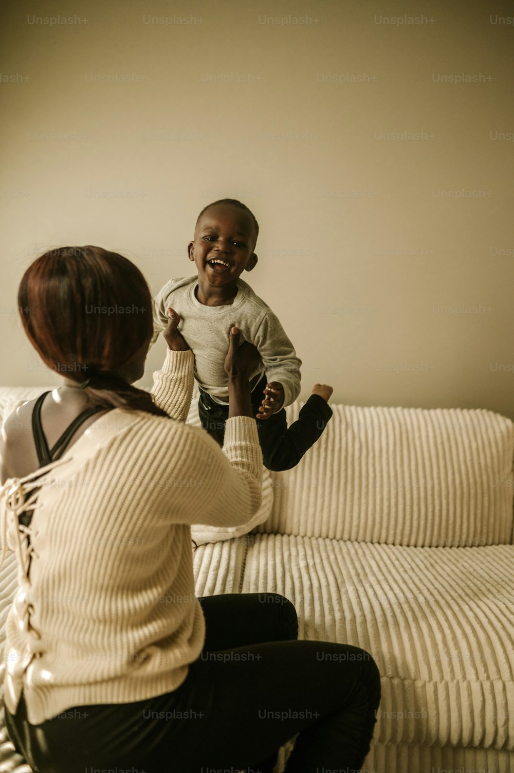 a woman and a child sitting on a couch