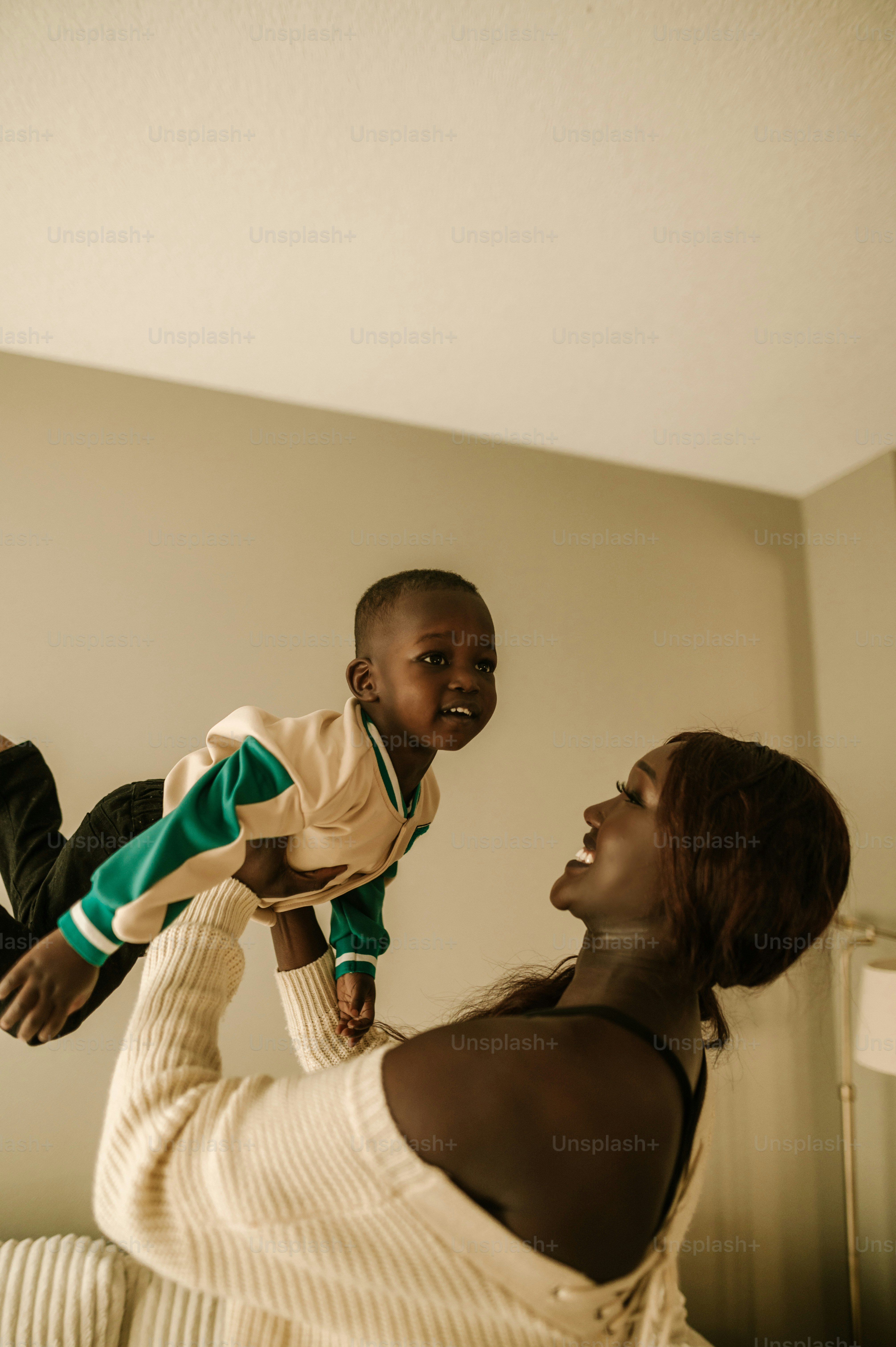 a woman holding a child up in the air
