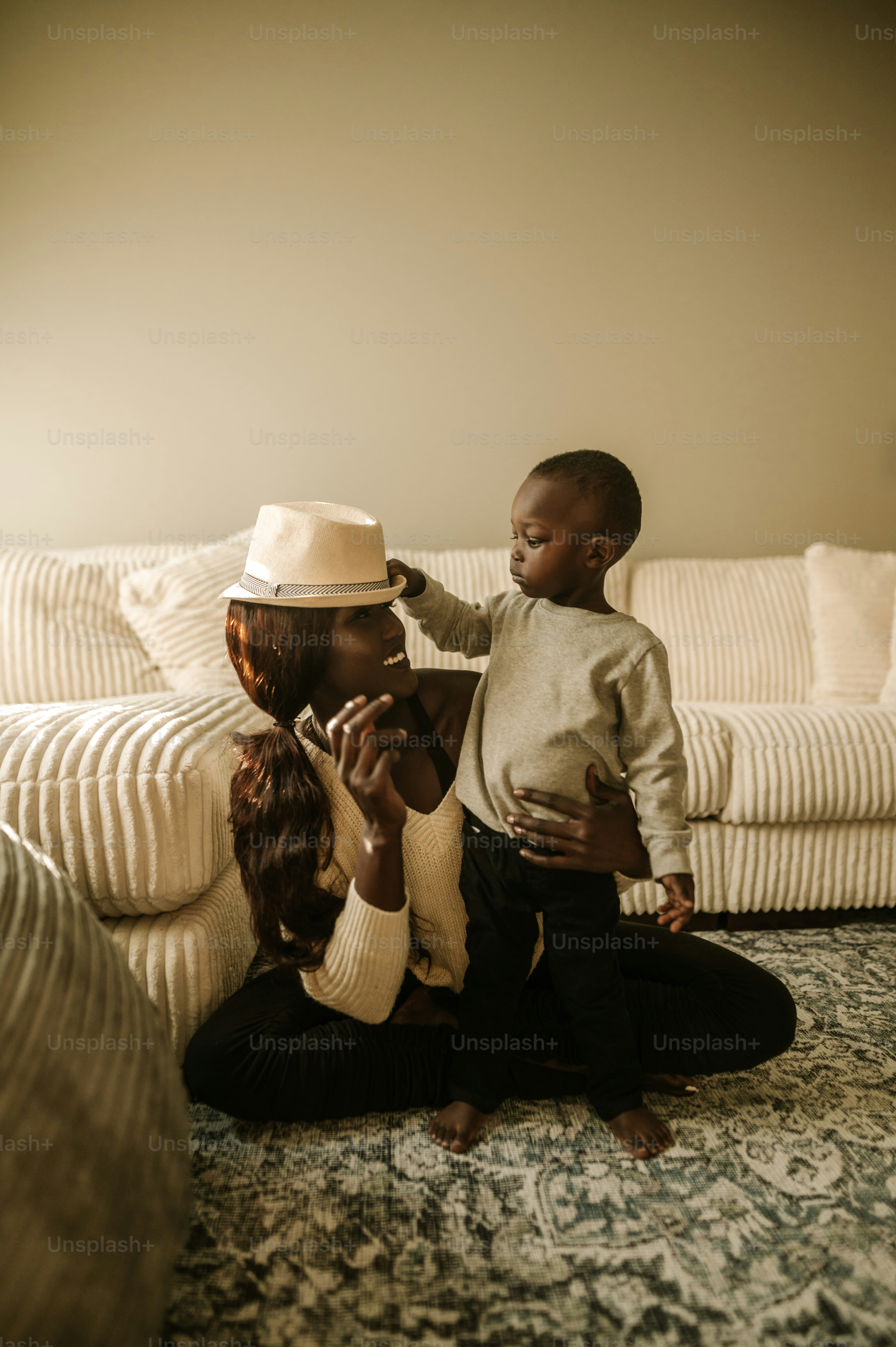 a woman and a child sitting on a bed