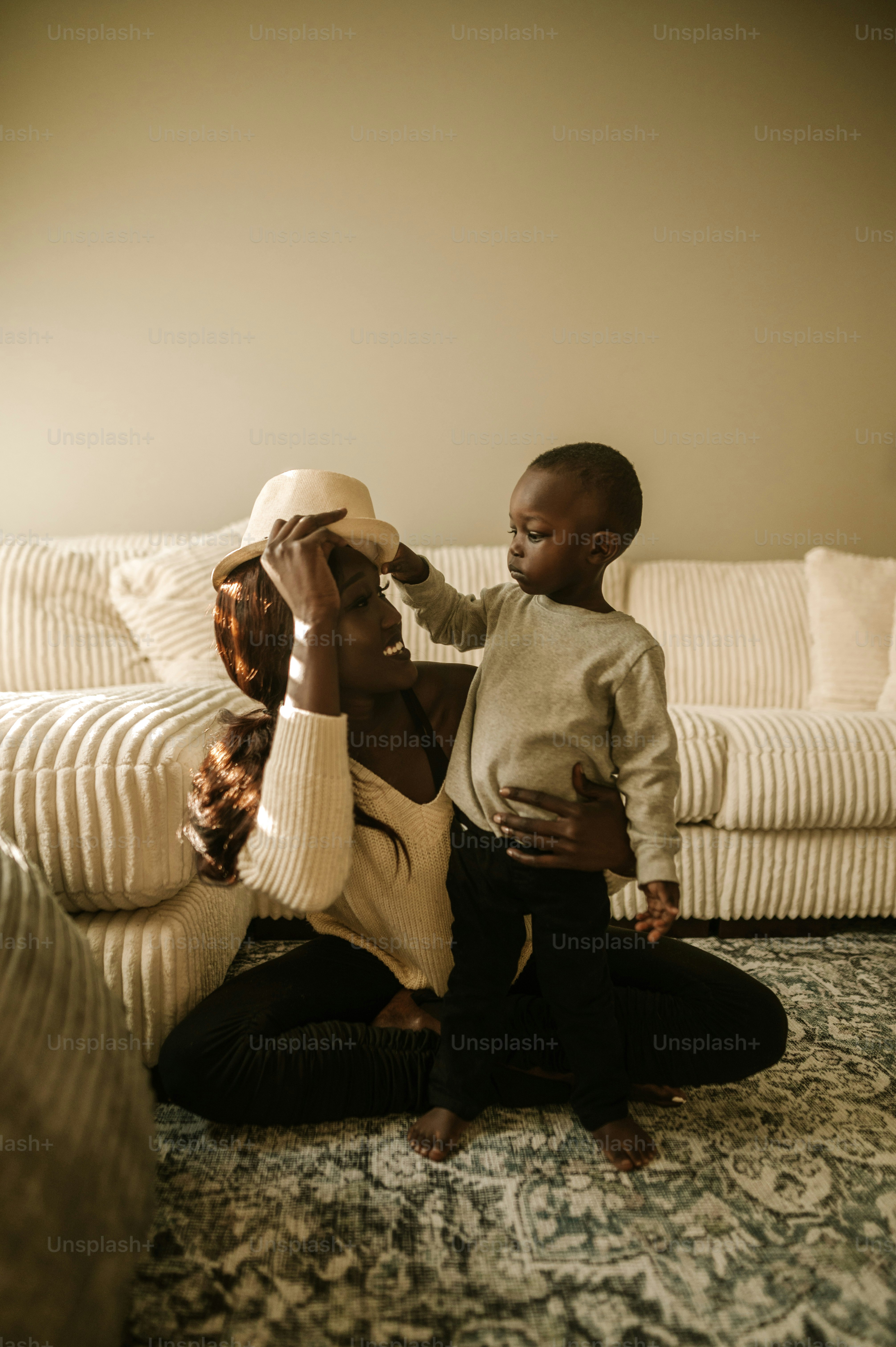 a woman sitting on the floor holding a baby