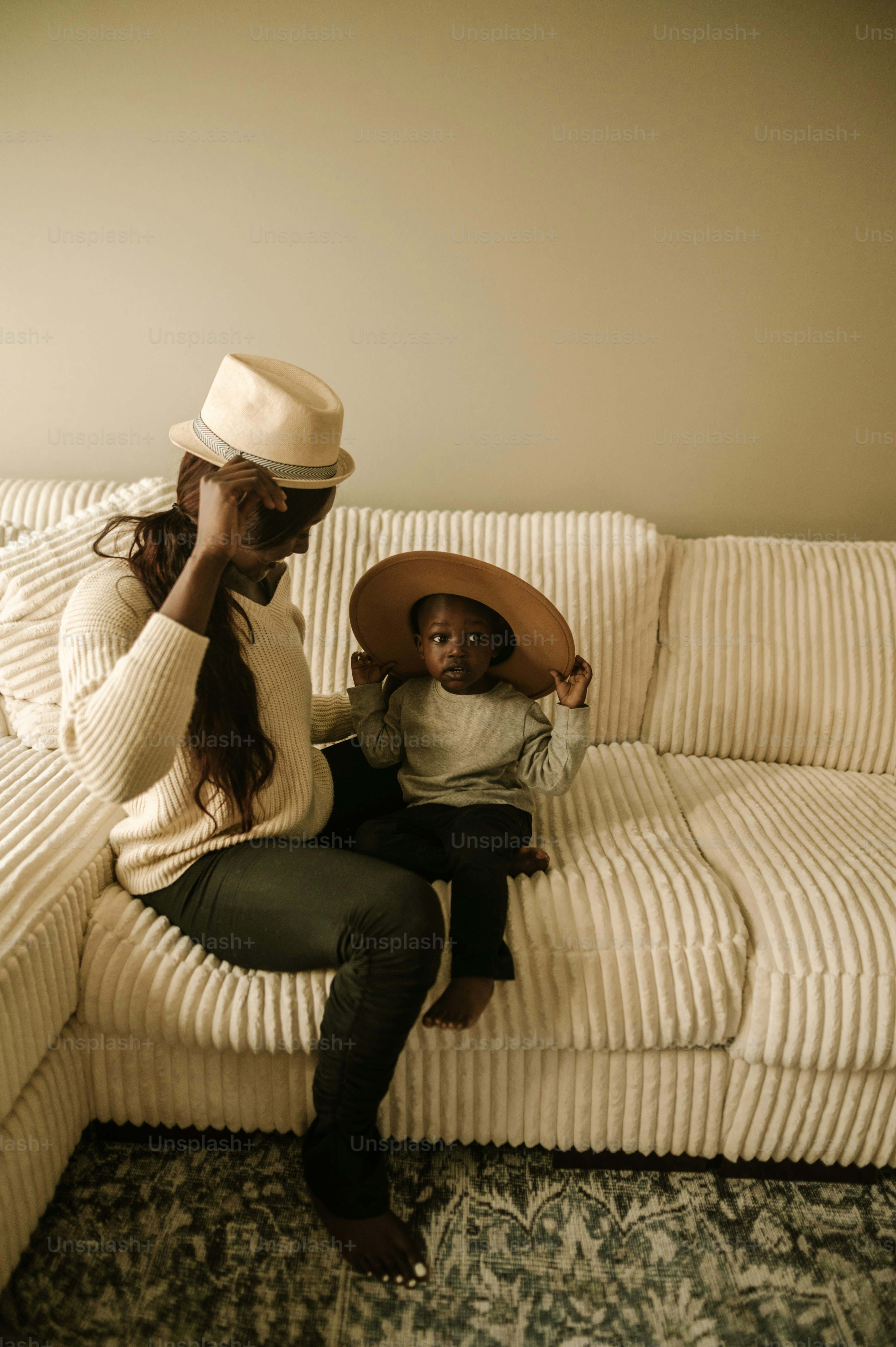 a woman sitting on top of a couch holding a child