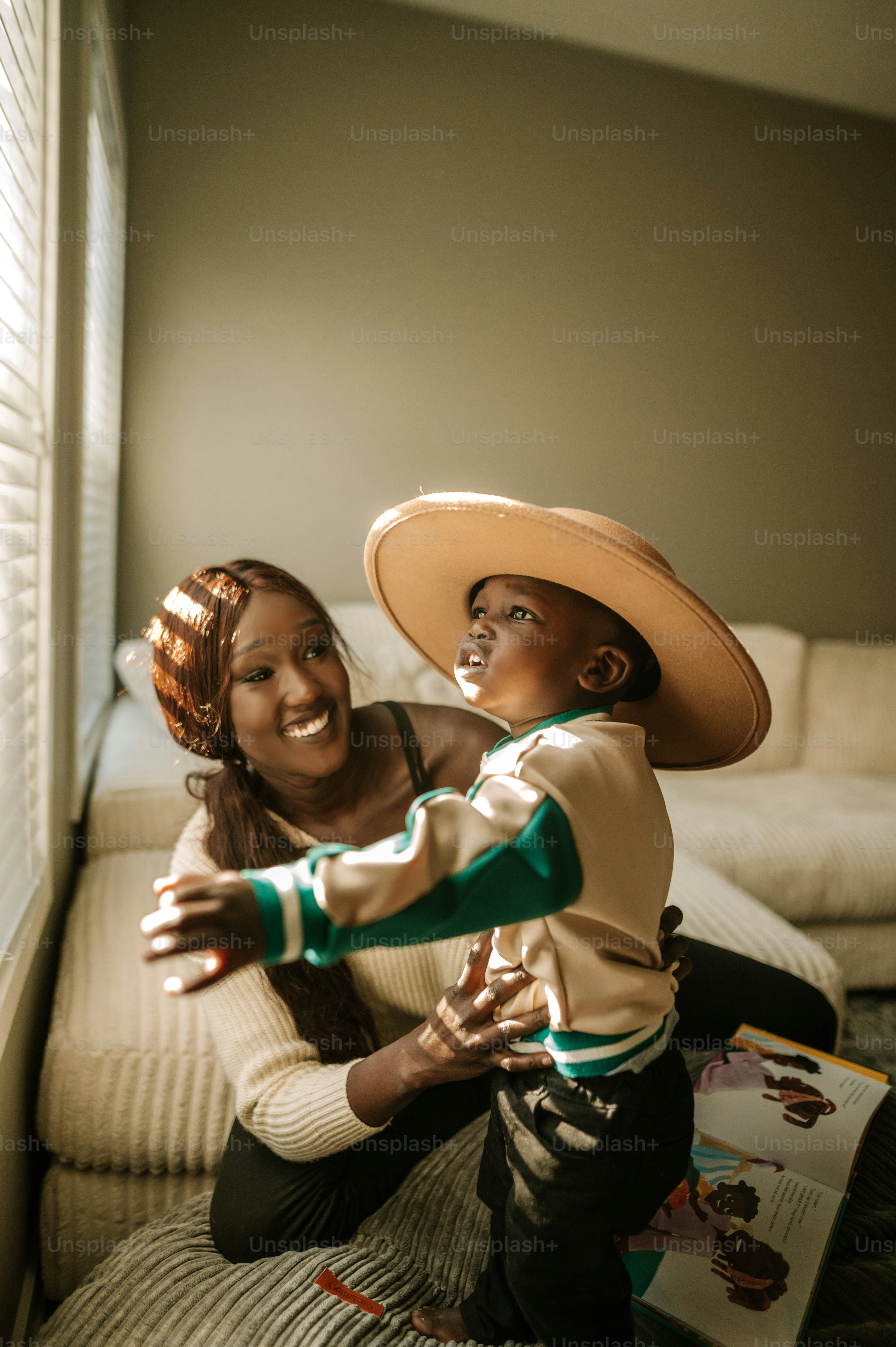 a woman and a child are sitting on a couch