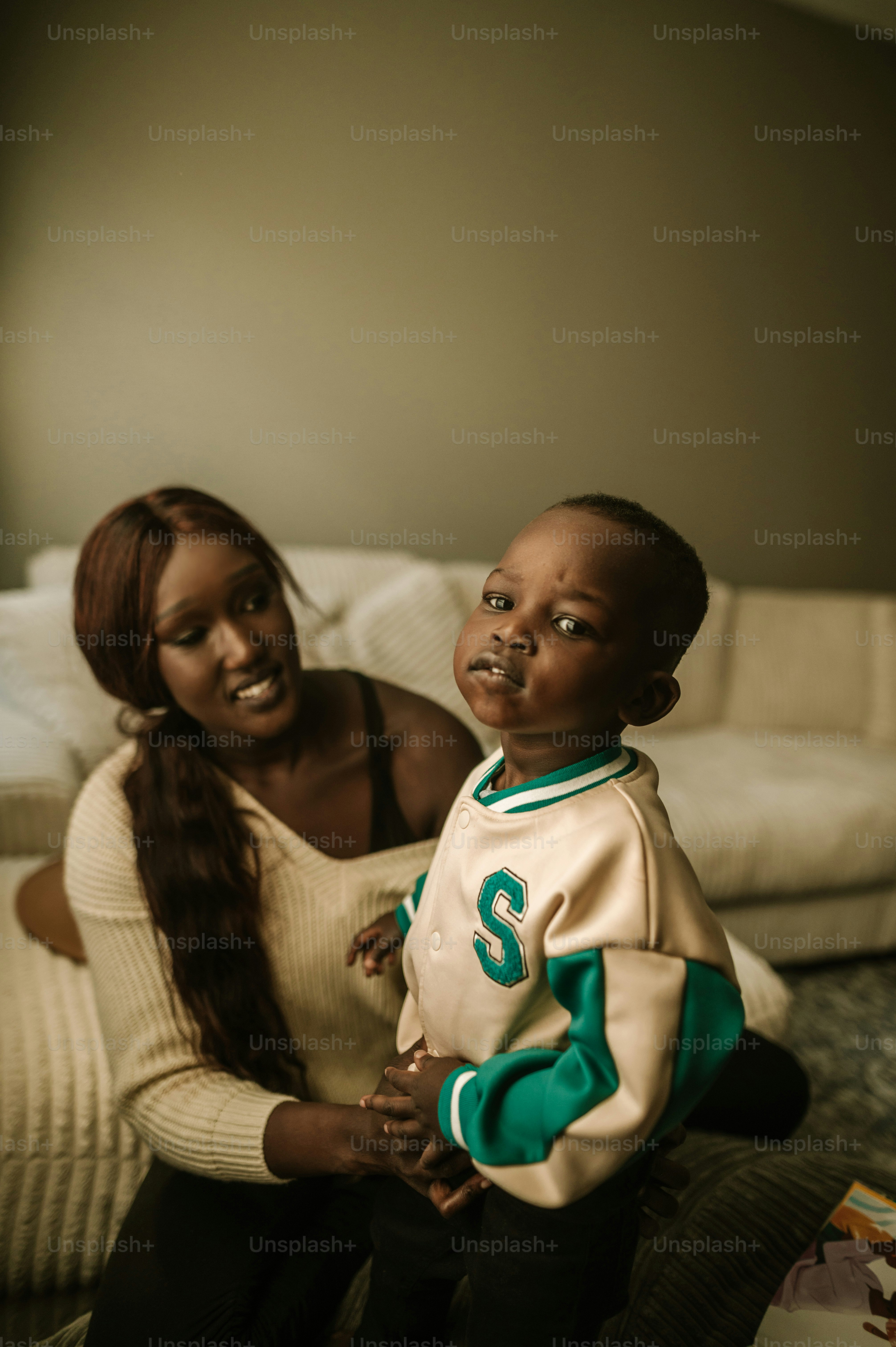 a woman and a child sitting on a couch