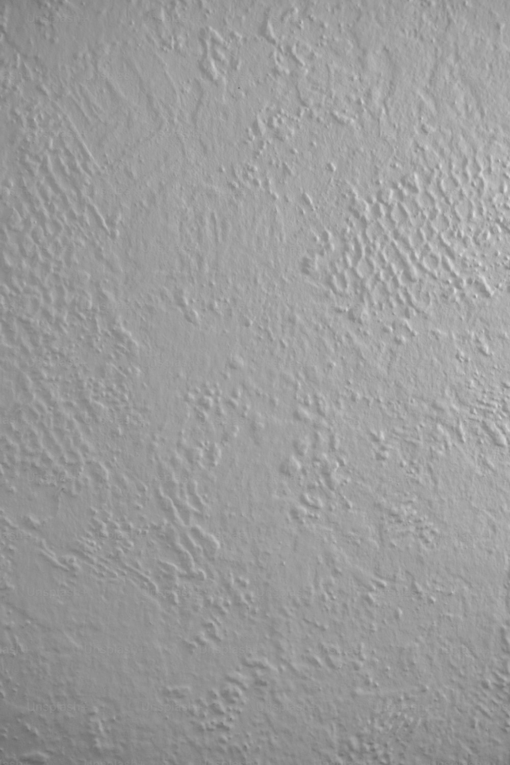 a black and white photo of a white wall