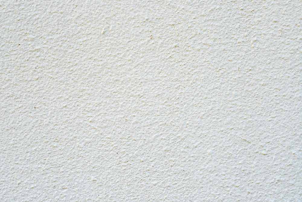 a close up of a white stucco wall