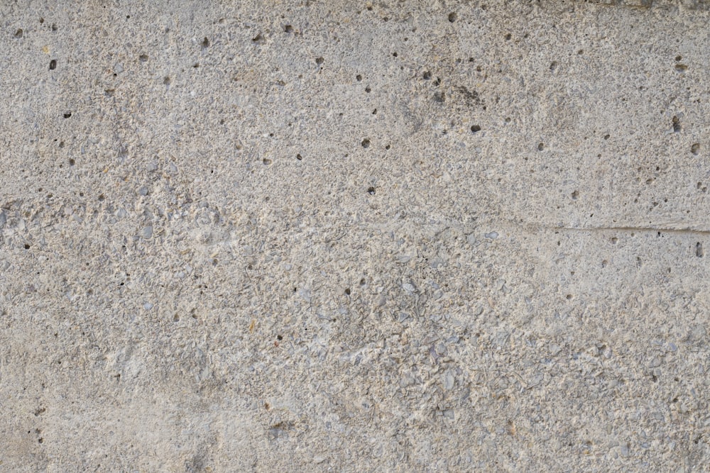 a close up of a cement surface with small holes