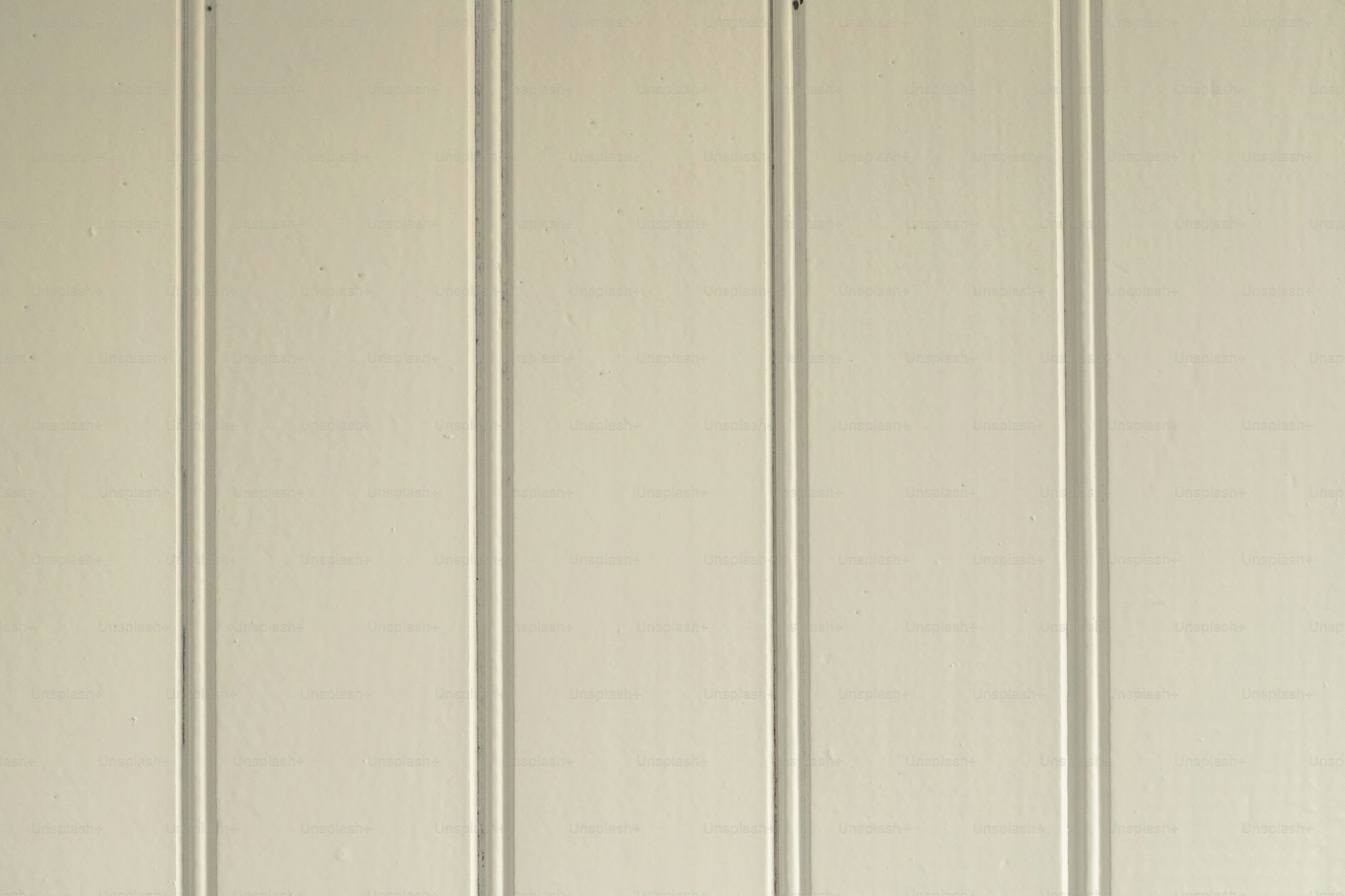 a white wall with a clock on the side of it