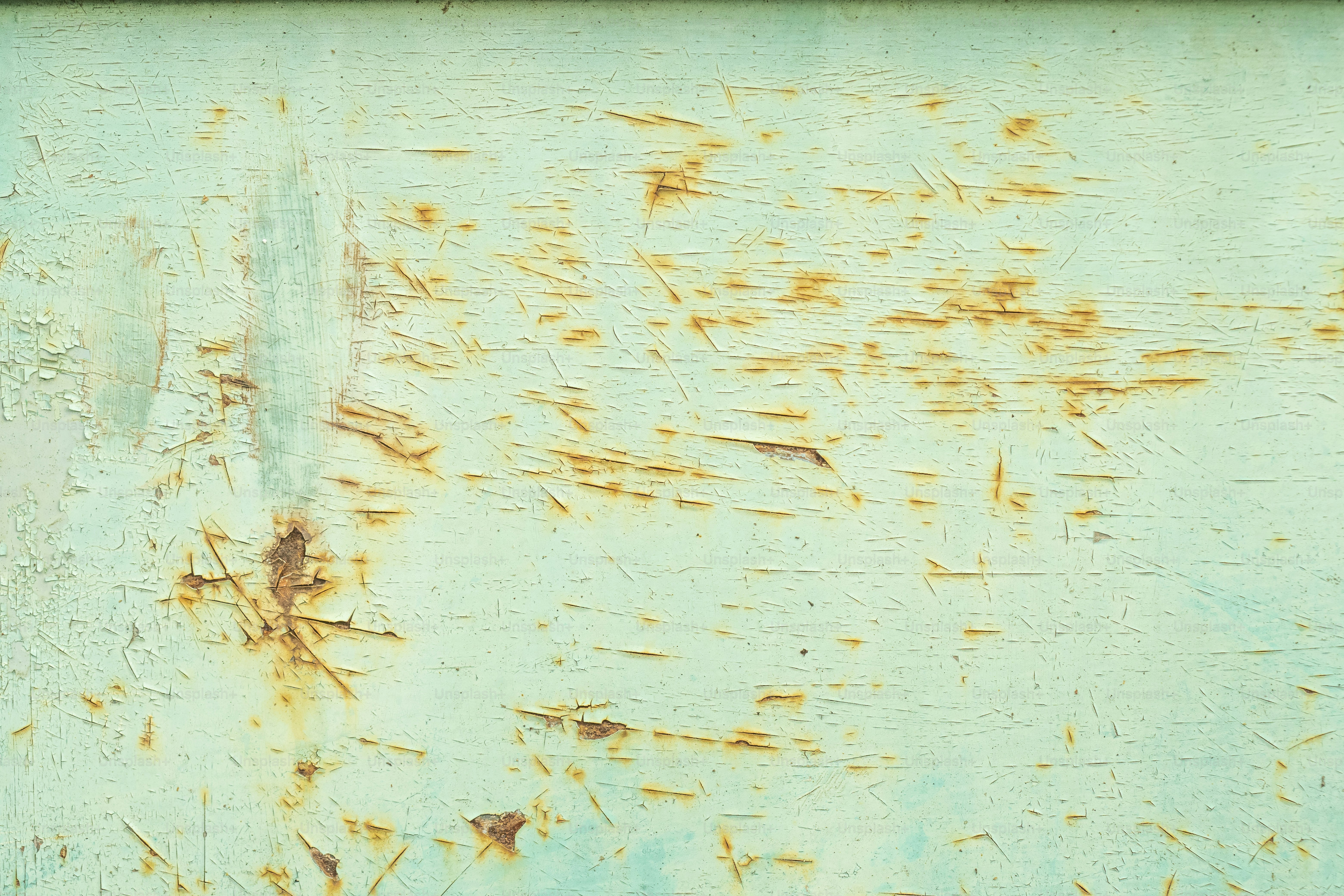 a rusted metal surface with a blue background
