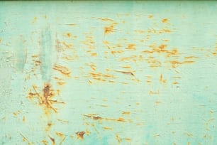 a rusted metal surface with a blue background