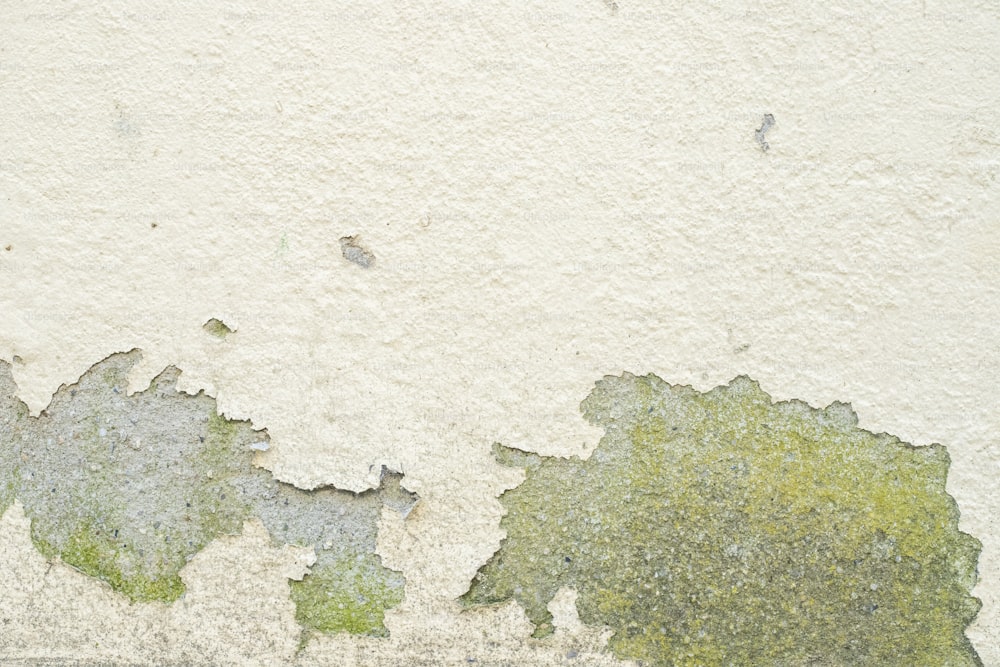 a close up of a wall with peeling paint