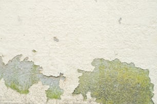 a close up of a wall with peeling paint